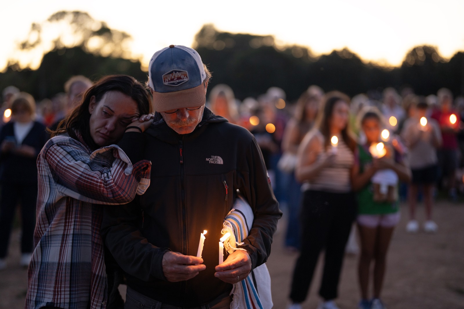 People gather for a candlelight vigil.