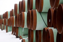 Large pipes stacked in snow