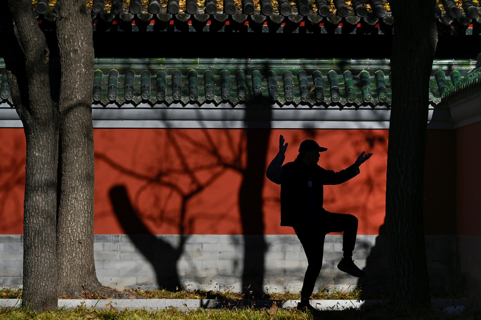 A man practices tai chi at a park in Beijing.