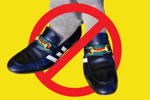 A pair of shoes inside a red cancel symbol