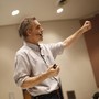 Jordan Peterson lecturing with a microphone.