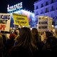 Demonstrators hold up signs during a protest against U.S. President-elect Donald Trump at the Puerta del Sol Square in central Madrid, Spain, December 2, 2016.