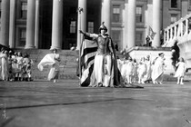 Suffrage pageant participants dressed in white stand in front of the Treasury Building, in Washington, D.C., on March 3, 1913.