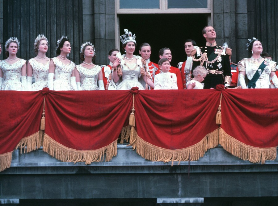 The Royal Family stands on the balcony of Buckingham Palace.