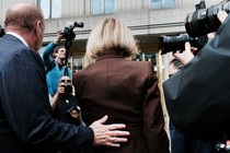 E. Jean Carroll walking into the Manhattan Federal Court building, surrounded by news photographers