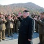 North Korean leader Kim Jong Un waving to North Korean officers during the launch of ballistic missiles