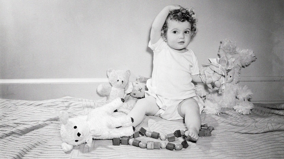 photograph of child playing with toys