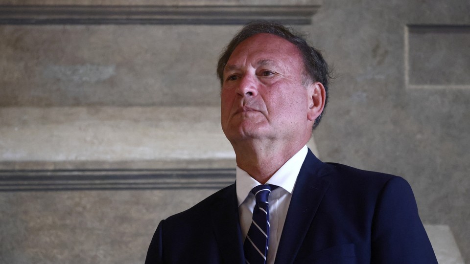 Photograph of Samuel Alito wearing a suit and tie from a low vantage point