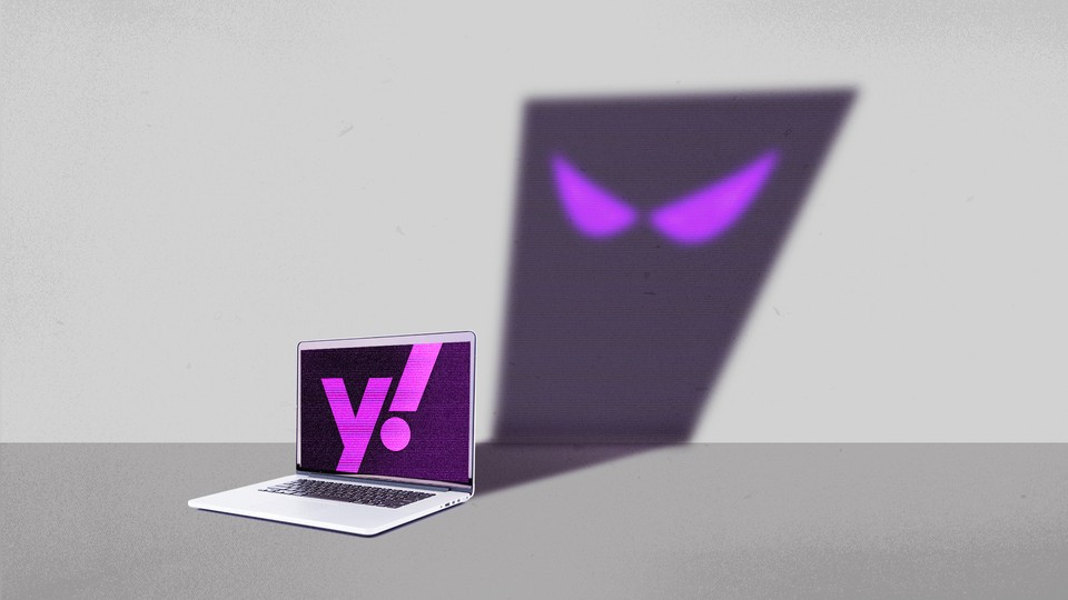 A laptop with a Yahoo logo on the screen, casting the shadow of a cartoon ghost