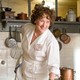 Meryl Streep in a white chef's outfit playing Julia Child