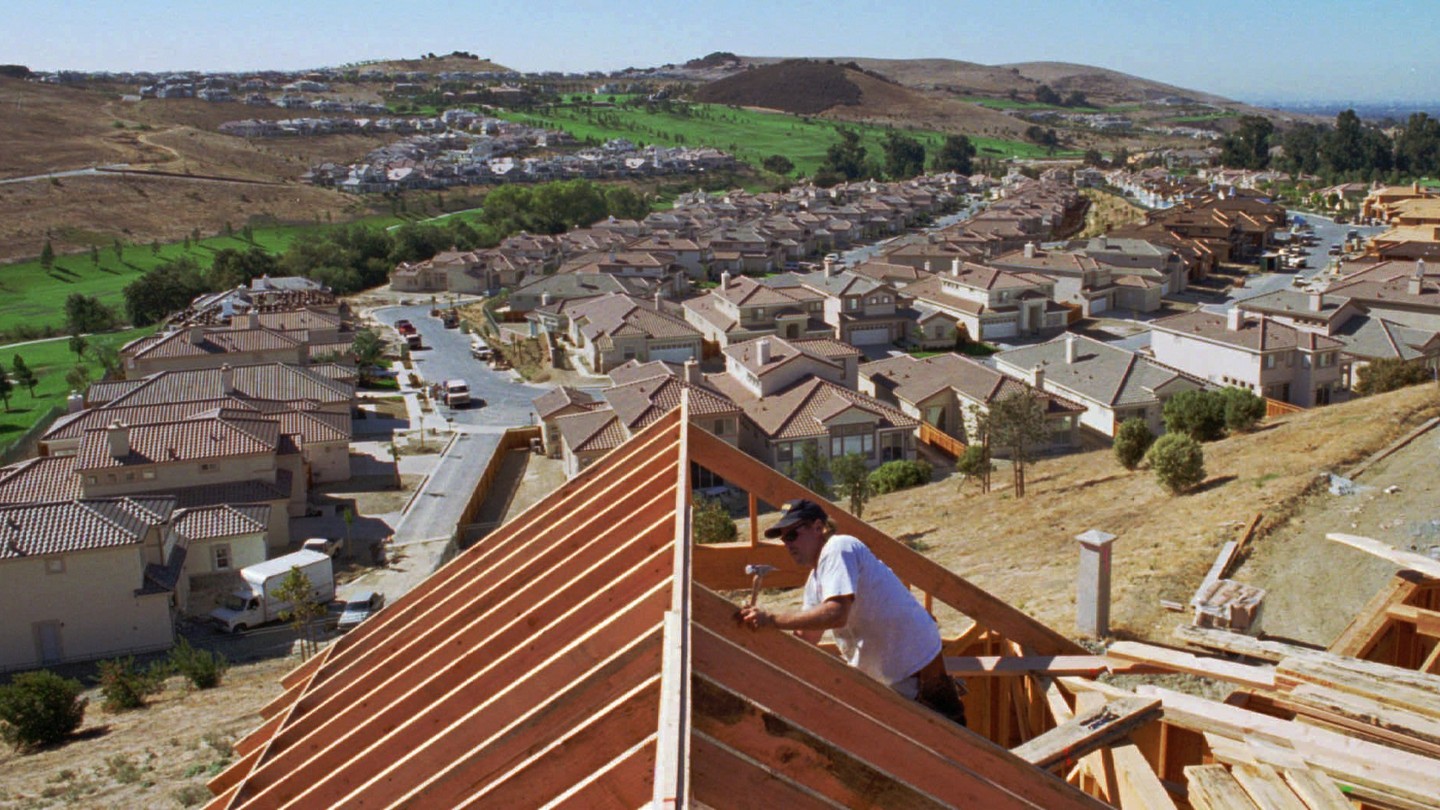 A worker builds new homes in San Jose.