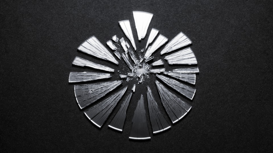 A broken mirror in the shape of the COVID virus