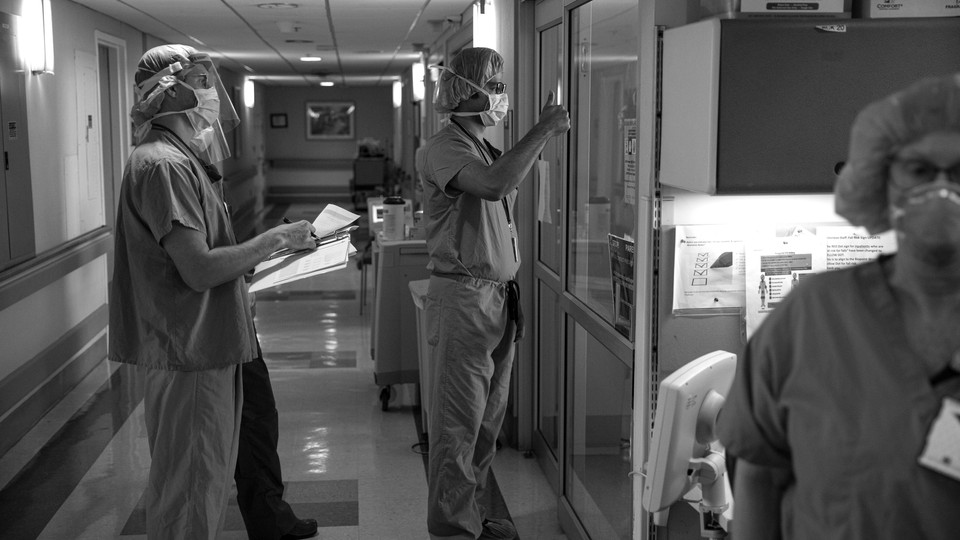 A medical doctor gives the thumbs-up sign to a COVID-19 patient who is no longer using a respirator at the Veterans Affairs Medical Center in Brooklyn.
