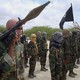 Al-Shabaab fighters display weapons as they conduct military exercises in northern Mogadishu, Somalia.
