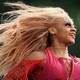 A picture of Sha’Carri Richardson with her hair flowing behind her