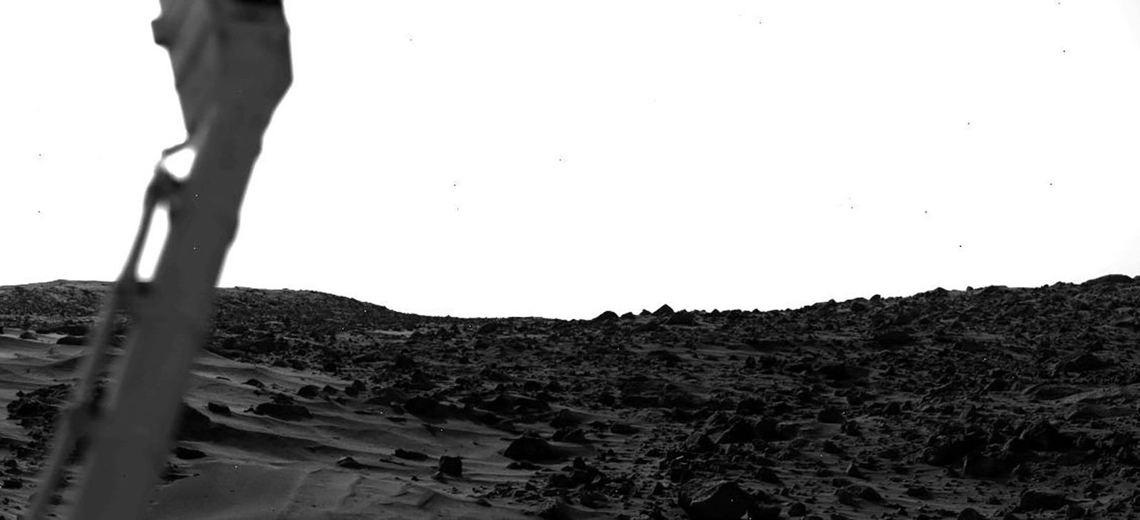 A bright sky, seen above the rocky Plains of Mars
