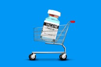 An enlarged COVID-19 vaccine vial in a shopping cart