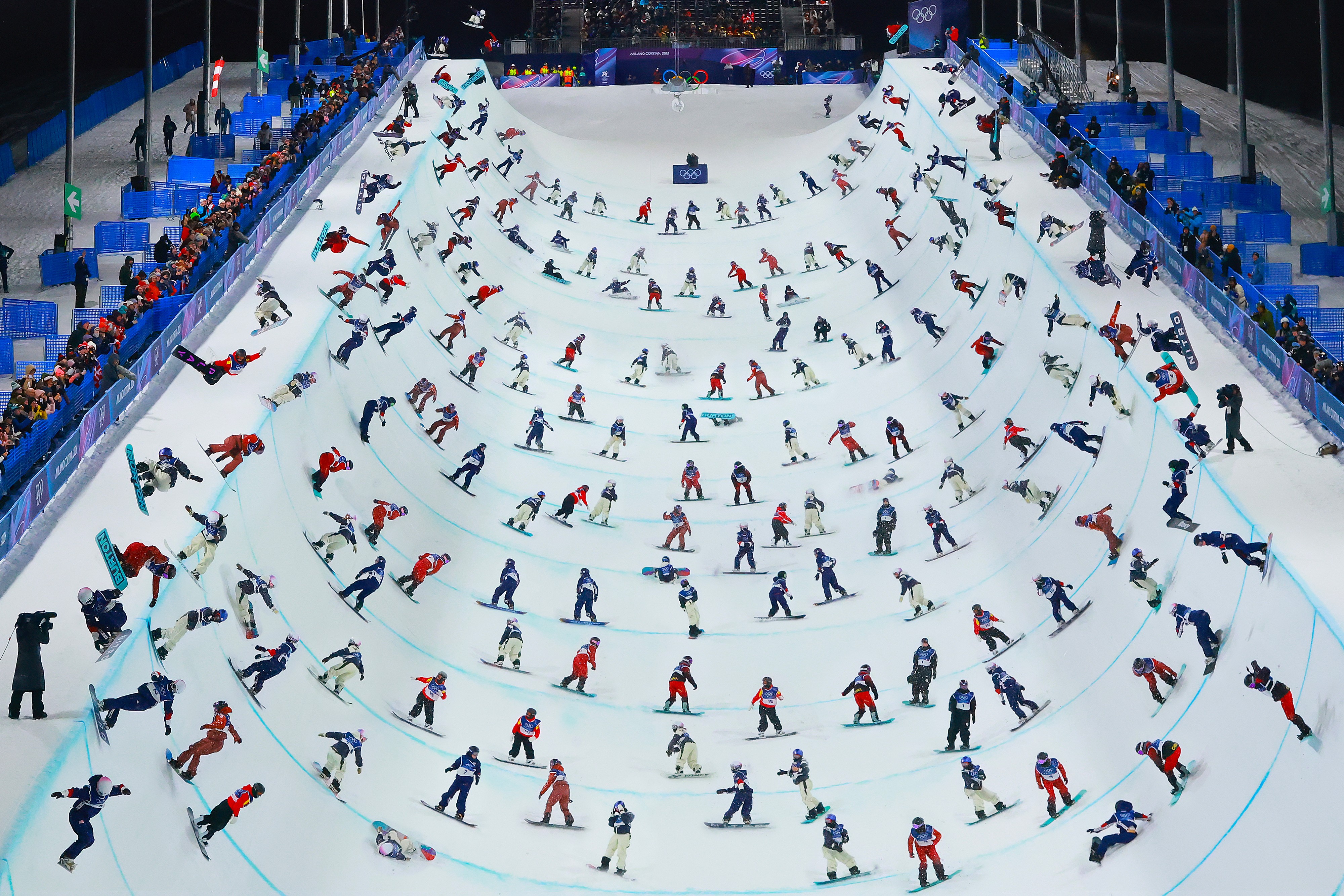 A composite image of many snowboarders inside a halfpipe, at varying points in different runs