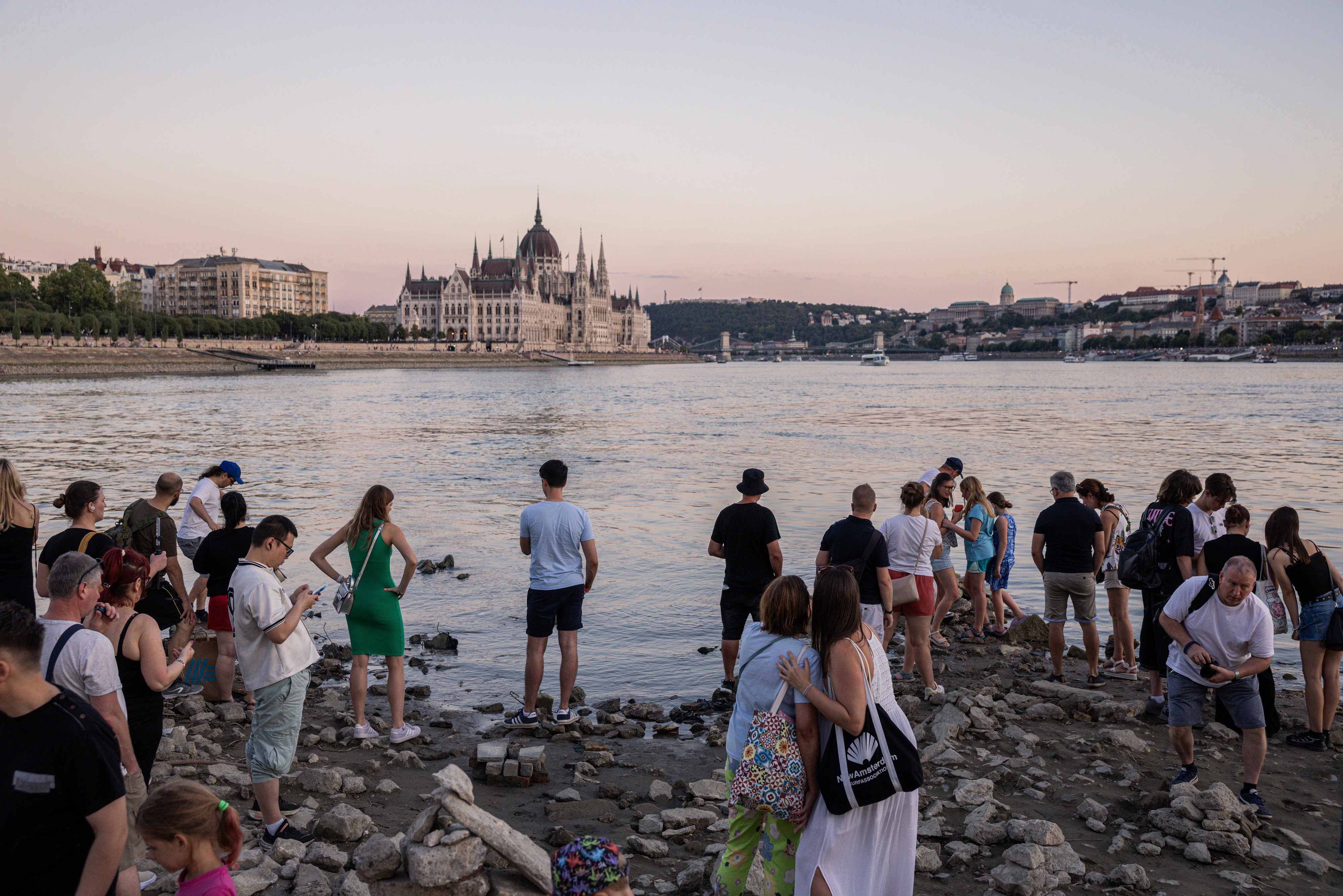 Visitors gather on an exposed section of riverbed during a heatwave in Budapest.