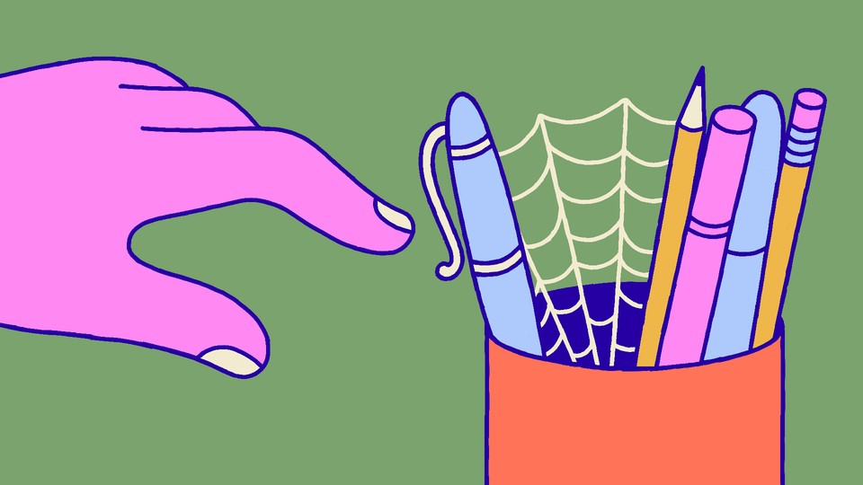 A hand reaching toward a pen holder with cobwebs in it