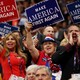 Delegates hold up signs that read "Make America First Again" during the opening of the third day of the Republican National Convention on July 20, 2016.