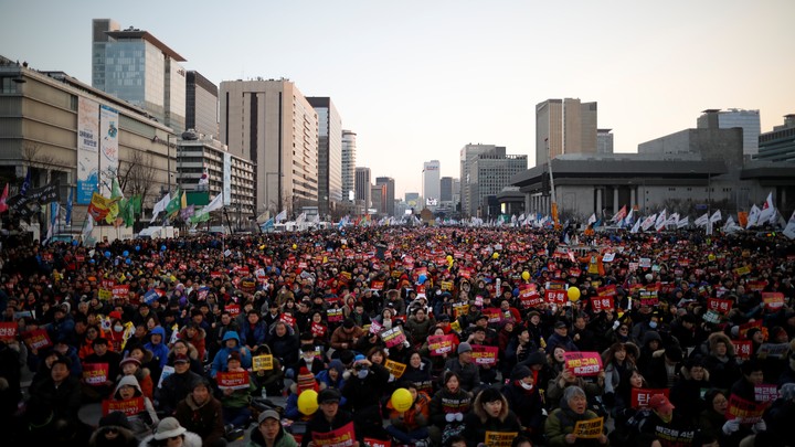 People attend a protest against South Korean President Park Geun Hye.