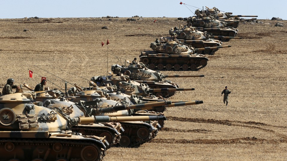 Turkish army tanks take up position on the Turkish-Syrian border near the southeastern town of Suruc in Sanliurfa province October 6, 2014