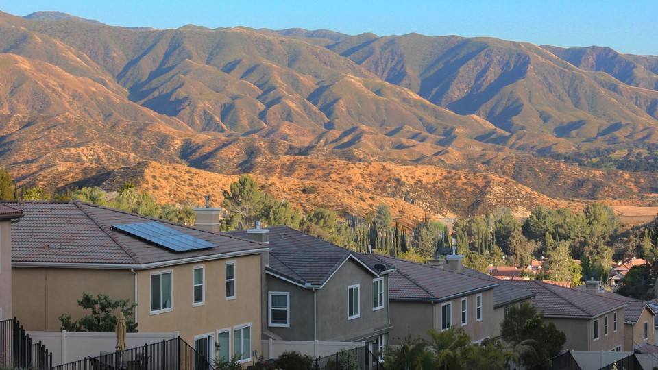 Photo of a row of homes in Santa Clarita, California, with hills in the background