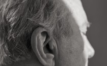 An older man's profile from behind