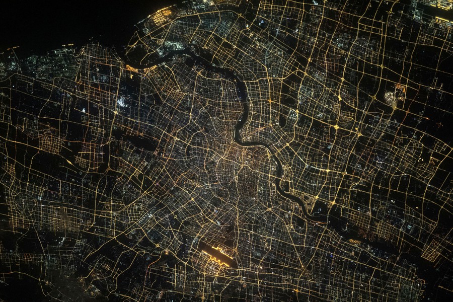 A night view of the streets and lights of Shanghai, seen from orbit