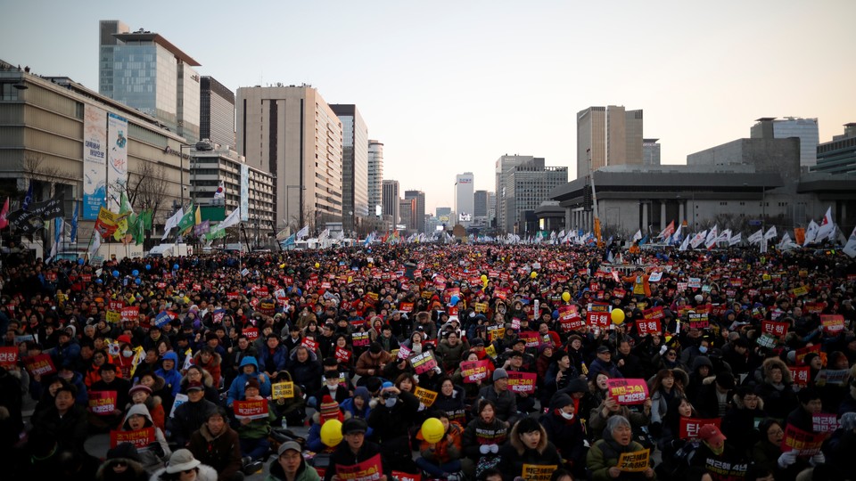 People attend a protest against South Korean President Park Geun Hye.