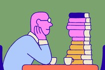 Man staring longingly at a stack of books