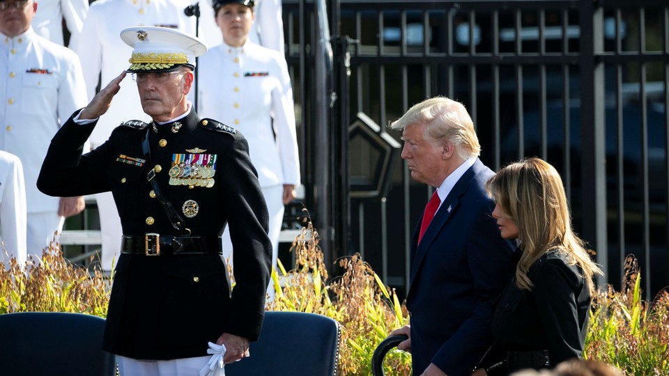 Joseph Dunford salutes as Donald Trump walks past.