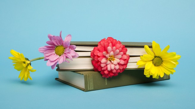 A book with flowers sticking out of it