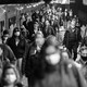 A black-and-white photo of commuters leaving a train in a station in New York City