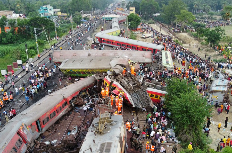 An aerial view of many derailed passenger-train coaches