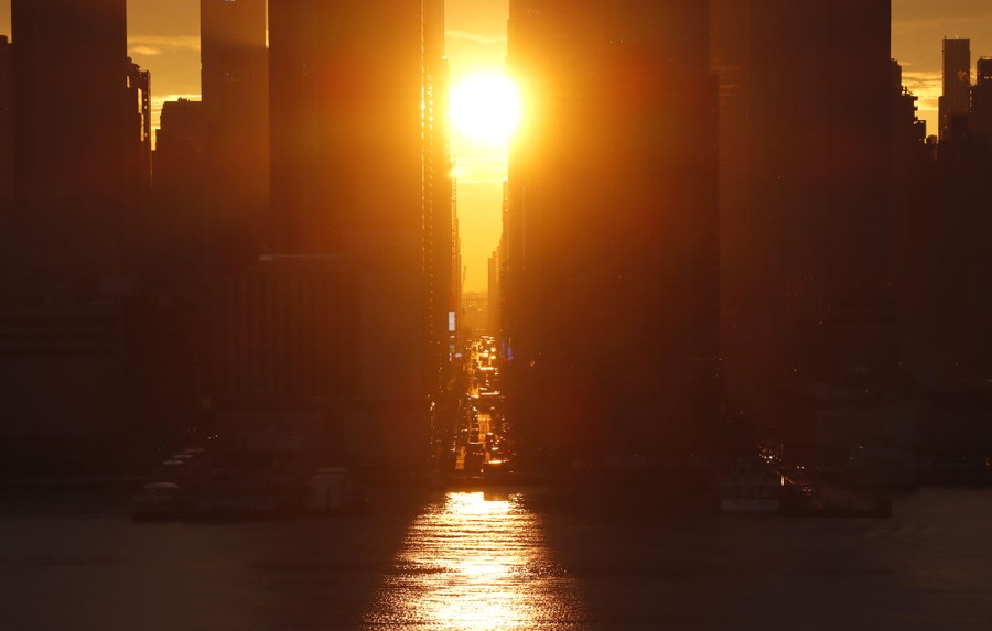A sunrise between tall city buildings