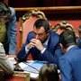 Matteo Salvini sits at a desk as he meets with other Italian lawmakers.