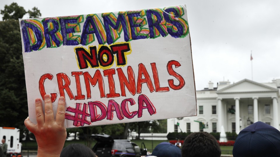 A woman holds up a sign in support of the Obama-administration program known as Deferred Action for Childhood Arrivals, or DACA.