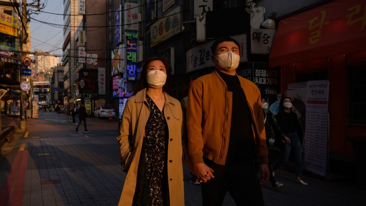 A couple in South Korea wearing facemasks