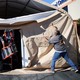 Workers take down an overflow patient care tent