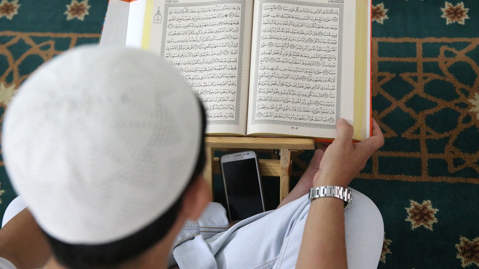 A Muslim man reads the Koran at Saigon central mosque in Vietnam.