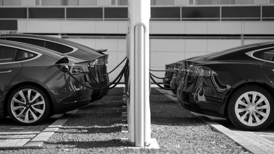 Five Tesla electric cars are shown charging in the Netherlands.