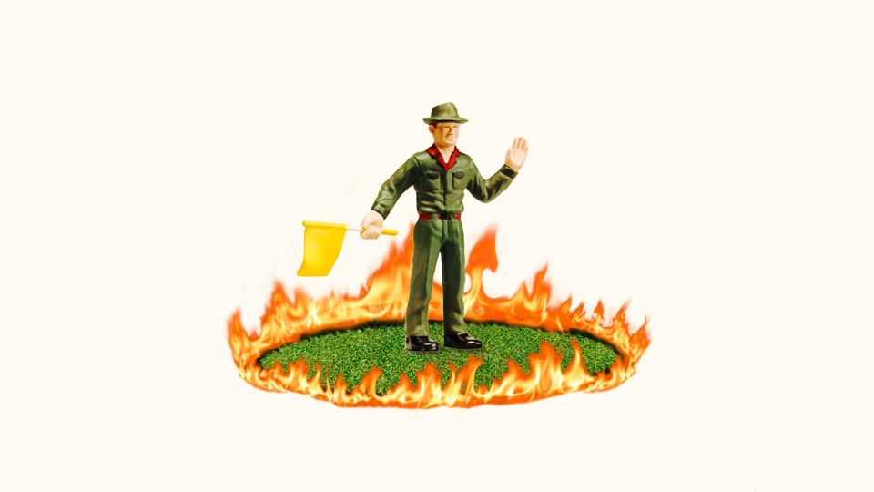 Photorealistic collage of a National Parks ranger figurine holding a yellow flag and standing in a patch of grass encircled by flames