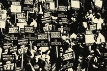 Black-and-white photo showing crowded protest. Many signs read "Writers Guild of America on Strike."