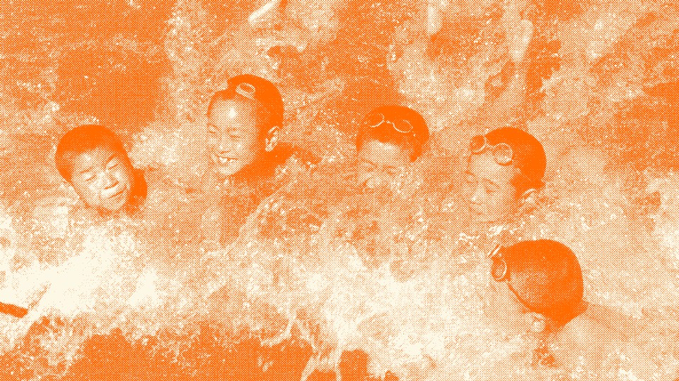 A group of 5 kids swims in water