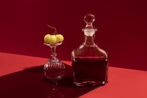 A red wine carafe on a red background