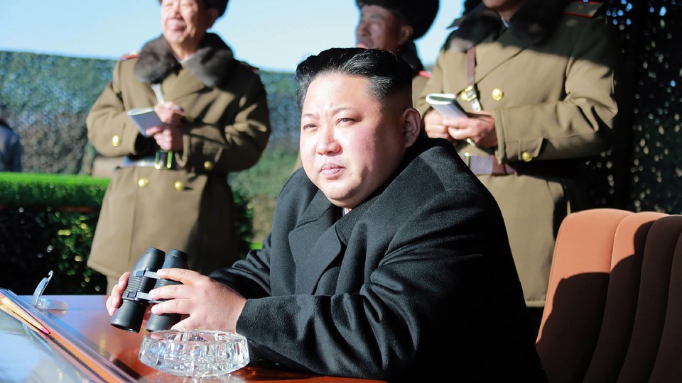 Kim Jong Un holds binoculars 