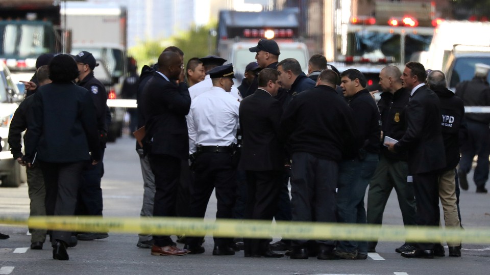 Police stand outside of the Time Warner building after a suspicious package was found inside CNN Headquarters