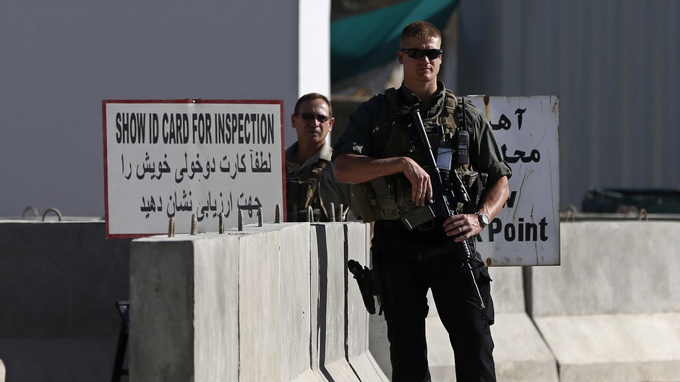 A foreign security contractor stands guard in Kabul.